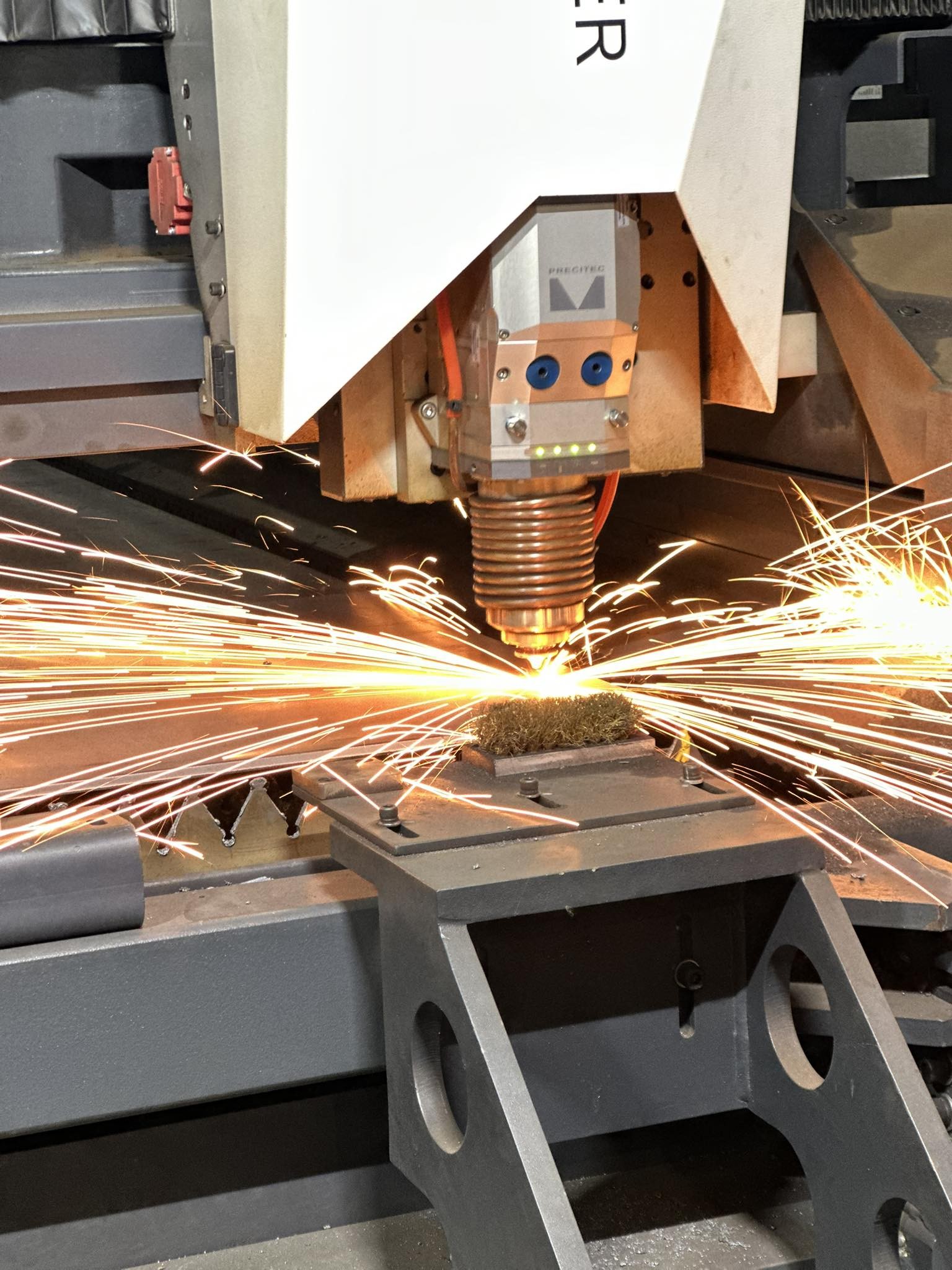 CNC laser cutting head with sparks at M-Steel Dandenong South