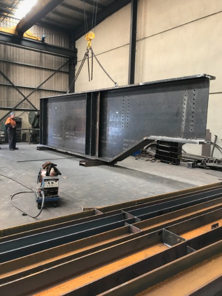 Large welded steel box girders being lifted in the M-Steel workshop