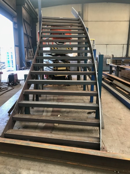 Custom curved steel staircase fabricated at M-Steel Dandenong South
