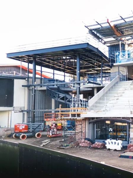 Fabricated structural steel columns, canopy and curved staircase during site installation
