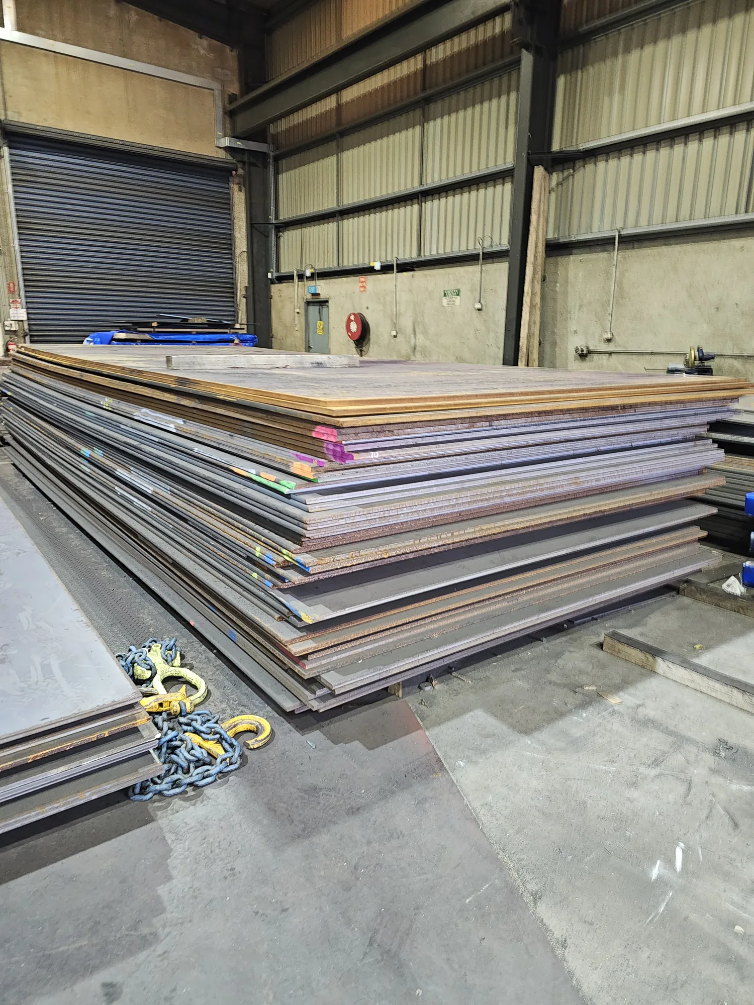 Steel plate stock with lifting chains at M-Steel Dandenong South